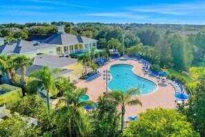 A resort with a large swimming pool, lounge chairs, and a building with a green roof. - 1st floor condo w/ gym, tennis court, sauna, patio, restaurant, near theme parks (Davenport)
