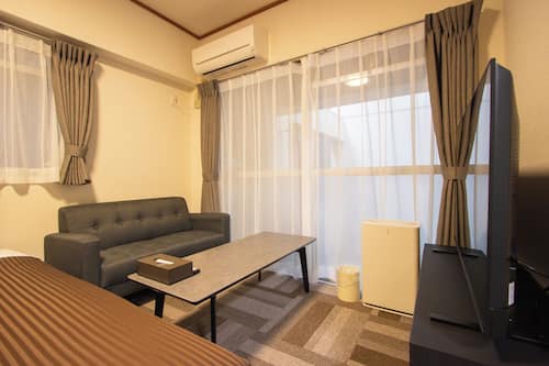 Standard Apartment | Living area | 50-inch Smart TV with digital channels