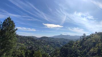 A panoramic view of a mountainous landscape with a village nestled among the hills.
