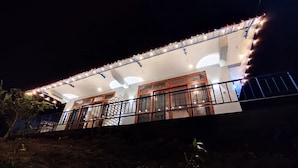 A building with a covered balcony area, large windows, and a railing. - Ella T & D Resort (Ella)