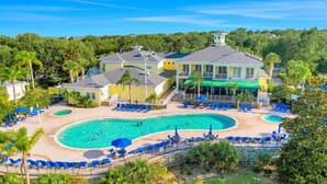 A resort with a large pool, multiple lounge areas, and a large building with balconies. - 1st floor condo w/ basketball court, sauna, restaurant, patio, gym (Davenport)