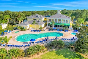 A resort with a large pool, multiple lounge areas, and a large building with balconies. - 1st floor condo w/ basketball court, sauna, restaurant, patio, gym (Davenport)