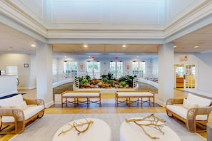 A spacious lobby with a central water feature, seating areas, and a view of the outdoor area. - Second floor condo w/ gym, shared pools, tennis court - near theme parks (Davenport)