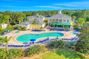 A resort with a large pool, multiple lounge areas, and a prominent building with a balcony. - 2nd floor condo w/ gym, shared pools, tennis court, balcony, sauna (Davenport)