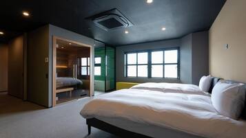 A modern bedroom with a large bed, a walk-in closet, and a window providing natural light.