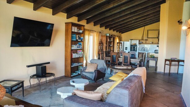 A spacious living area with a sofa, armchairs, and a bookshelf. - Horse guest house (Piemonte)