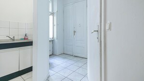 A kitchen with white cabinets, a sink, and a window. - Simple 2BR Apt near Belvedere Palace (Vienna)