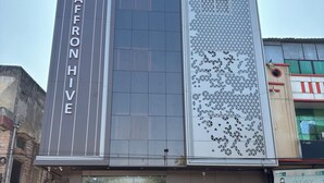 A modern building with a prominent sign reading "SAFFRON HIVE". - Hotel Saffron Hive (Jodhpur)