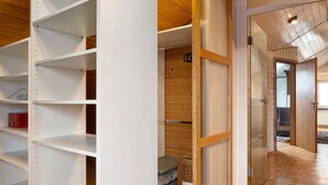 A room with white shelving units, a wooden floor, and a door leading to another room. - Apartment 'Witt' with Whirlpool, Palm Garden, and Terrace (Salem)
