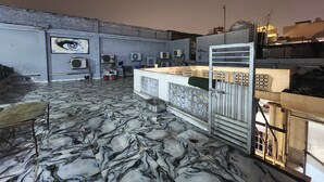 A rooftop terrace with a marble floor, a bar area with a counter, and multiple air conditioning units. - Hotel Kelson DX-Near Ramakrishna Metro (New Delhi)