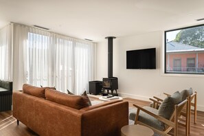 TV, fireplace - Apartment Two - Apartments on Gavan - Welcome to Your Luxurious Getaway at Apartments on Gavan. (Bright)