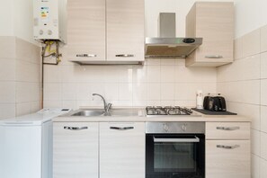 A modern kitchen with a built-in washer, stainless steel appliances, and light-colored cabinetry. - GuestHost - A comfortable and welcoming 55 square meters apartment, perfect for four people, located on the mezzanine floor of a building (accessible via a few steps).The property is located between the vibrant Chinatown district and the Sempione area, M (Milan)