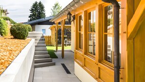 A covered outdoor staircase leading to a building with large windows and a stone wall. - Holiday Home 'Ferienhaus Apfelbäumchen Lenzkirch' with Mountain View, Private Terrace and Wi-Fi (Lenzkirch)