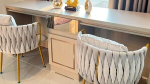 A modern room with a desk, two chairs, and decorative items. - ✈️ How to Get from Don Mueang Airport to The Rise 789 (Tambon Lak Hok)