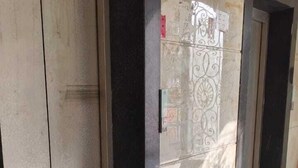 A corridor with two doors, one of which is slightly ajar. - Brij Darshan (Vrindavan)