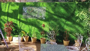 A garden area with a sign that reads "I ♥ Hotel New Sun n Rock" against a backdrop of green artificial grass. - Hotel New Sun n rock (Mount Abu)