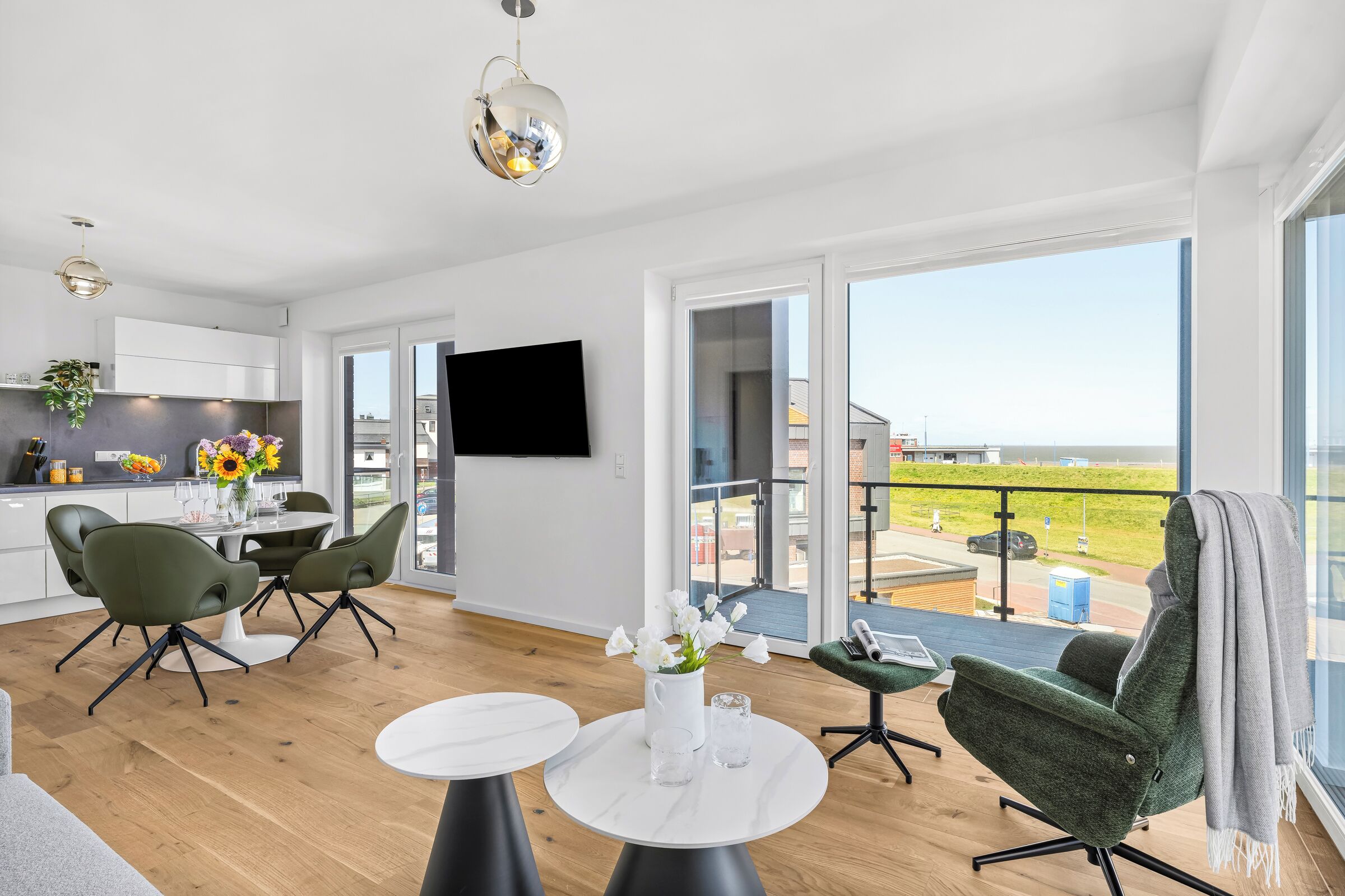 A modern apartment with a balcony, a kitchen, and a dining area.