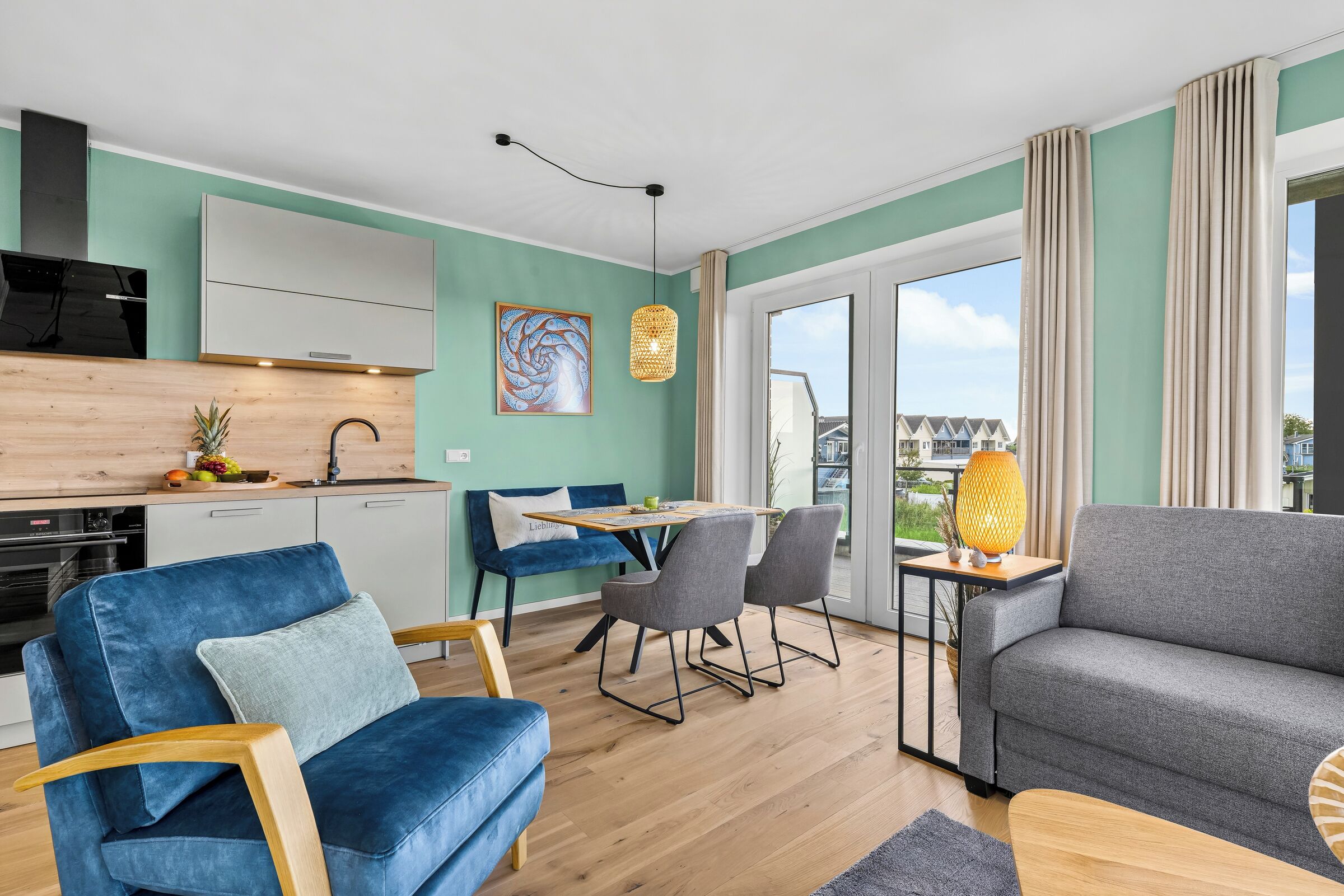 A modern apartment with a kitchen, dining area, and living room.
