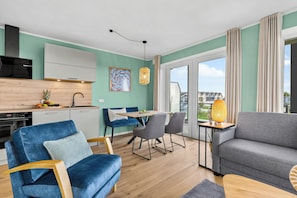 A modern apartment with a kitchen, dining area, and living room. - The View C06 Strandflieder - 1st floor, shared sauna, parking (Dagebüll)