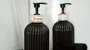 Two black bottles with pump dispensers, one labeled "Shampoo" and the other "Duschgel". - Vacation apartment - beautiful home Li-Apartments (Pforzheim)