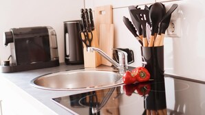 A modern kitchen with a stainless steel sink, a toaster, and a coffee maker. - Vacation apartment - beautiful home Li-Apartments (Pforzheim)