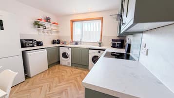 Fridge, stovetop, coffee/tea maker, dining tables