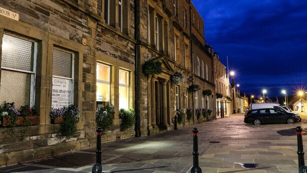 A stone building with a sign for 'Skippa's Bar' and 'National Orkney Pub' on the ground floor. - Royal Oak Court Retreat (Kirkwall)