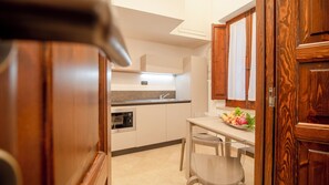 Standard Apartment | Private kitchen | Full-size fridge, microwave, stovetop, cookware/dishes/utensils