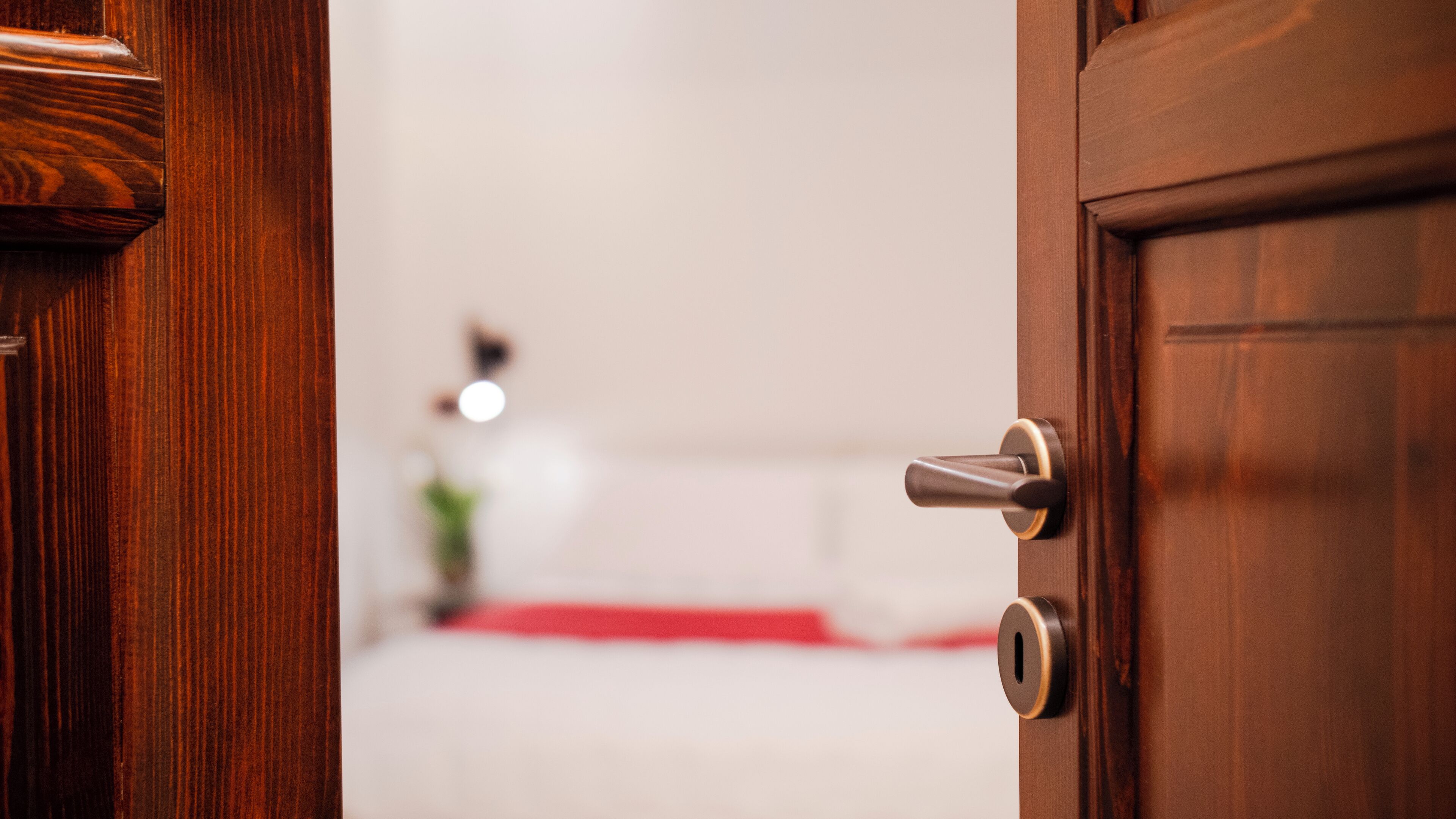 A wooden door with a modern lock and keyhole.