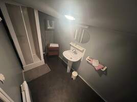 A small bathroom with a sink, mirror, and towel rack.