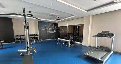 2-bedroom apartment in serene GIFT city with AC, Pool, Gym, Family/Business Stay