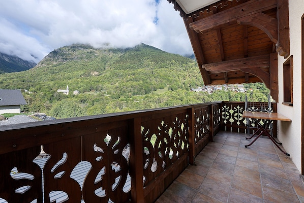 A balcony with a view of a mountainous landscape.