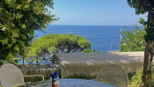 An outdoor dining table with food and drinks, overlooking a scenic view of the sea. - Luxury Apartment with Sea View, Perfect for Couples and Mature Guests (Dehesa de Campoamor)