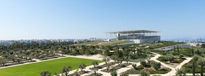 A modern building with a flat roof and a large open space in front. - Socrates Path (Athens)