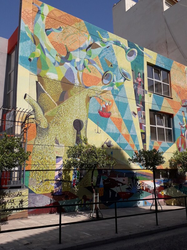 A building with a colorful mosaic mural on its exterior. - Alexandra s Path (Athens)