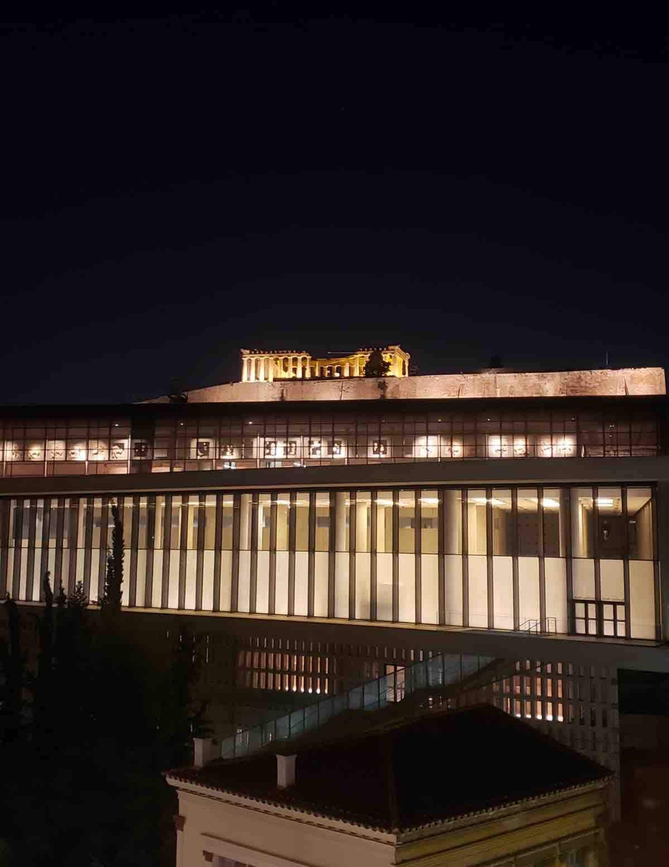 A modern building with a flat roof and large windows.