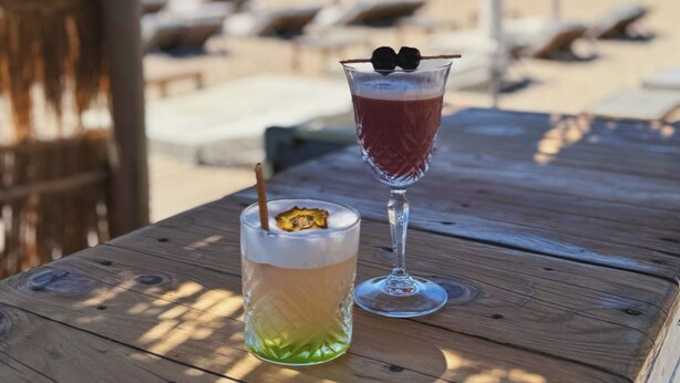 Two drinks on a wooden table with a beach view in the background. - Beautiful Mediterranean villa with large pool ideal for families (Villeveyrac)