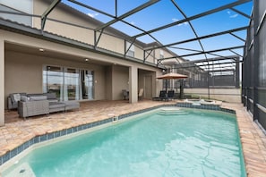 A swimming pool with a glass ceiling, a patio area with outdoor furniture, and a view of the surrounding landscape. - Super Wow- 8bdr-6bas Sick Lake Views (Kissimmee)