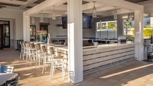 An outdoor bar area with a counter, seating, and hanging lights. - Toy Story Villa - 5BD Game Room Pool Spa Near Disney (Davenport)