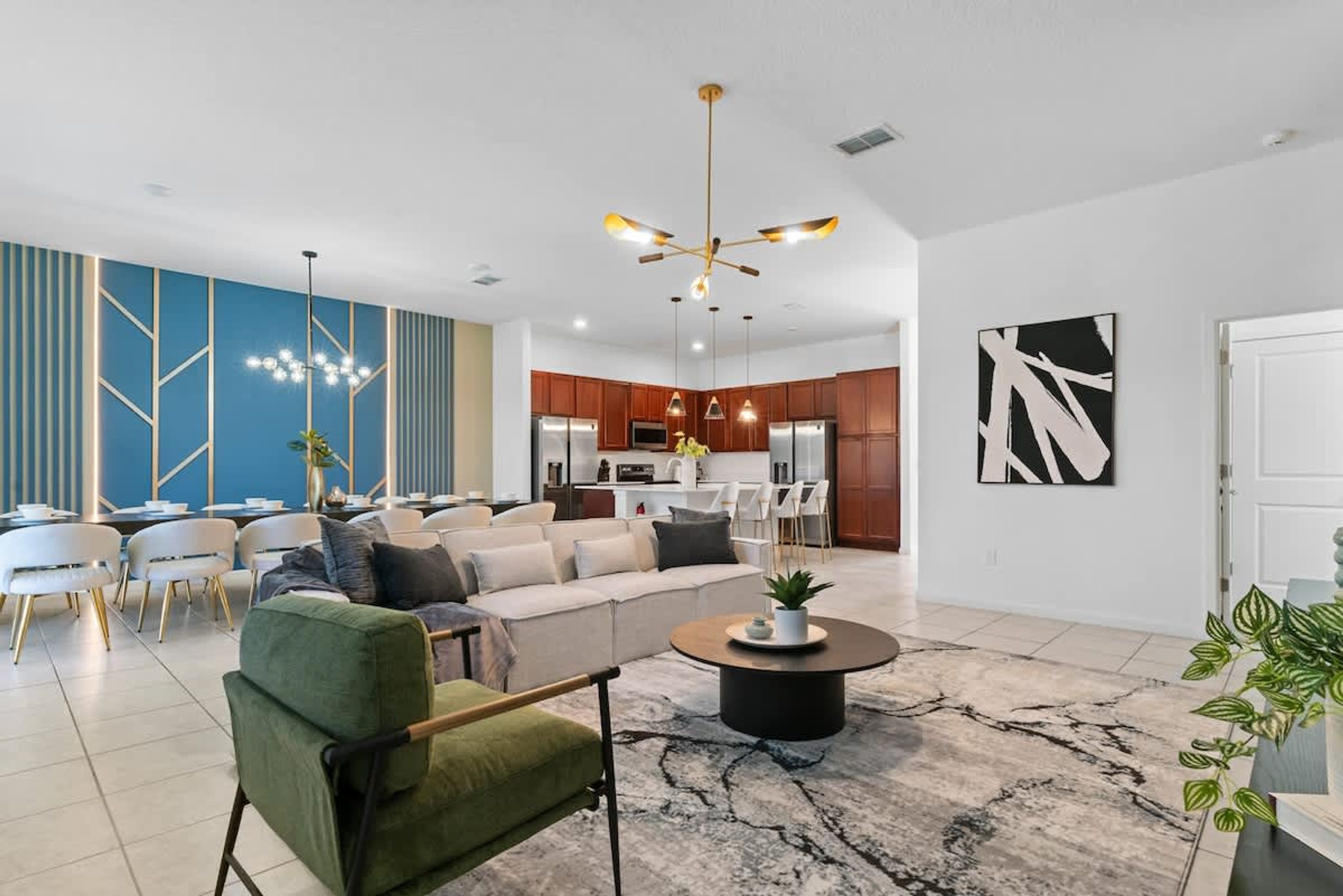 A modern living room with a sofa, coffee table, and dining area.