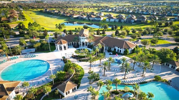 A resort with multiple swimming pools, a golf course, and a large building with a dome. - Pool Spa Arcade Games - 5 min Walk to Water Park (Kissimmee)