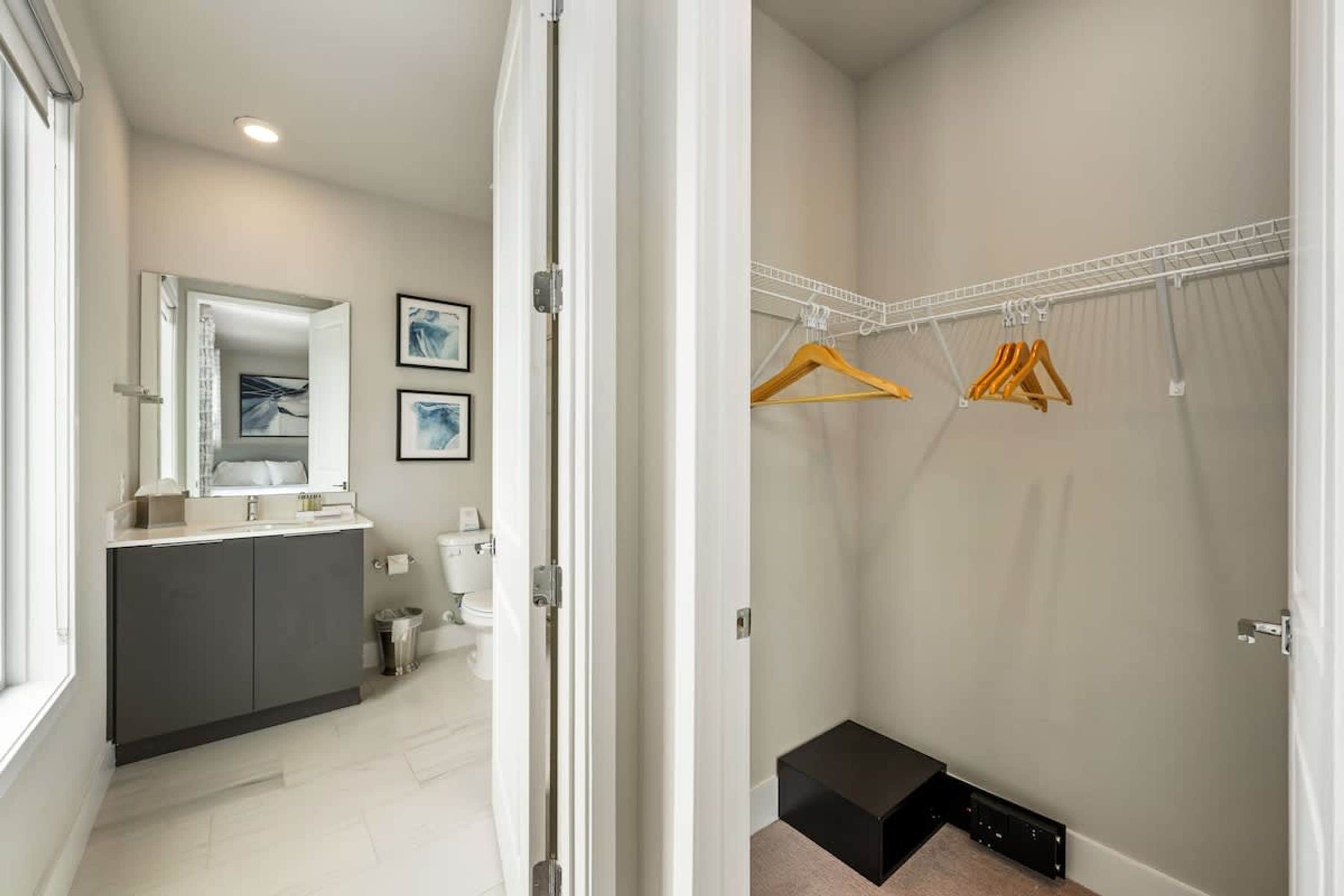 A modern bathroom with a vanity, toilet, and shower area.
