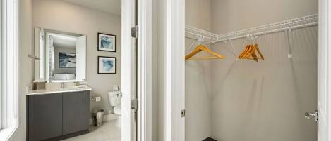 A modern bathroom with a vanity, toilet, and shower area.
