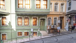 A multi-story building with a green door and multiple windows. - Acme Studio 2 (İstanbul)