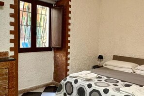 1 bedroom, desk, iron/ironing board, travel crib