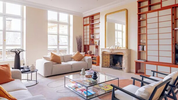A spacious living room with a fireplace, a sofa, a coffee table, and a bookshelf. - JUST STEPS AWAY FROM THE MONNAIE MUSEUM, SEINE RIVER & PONT NEUF – SAINT GERMAIN (Paris)