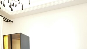 Una habitación de hotel moderna con cama, escritorio, televisor y minibar.