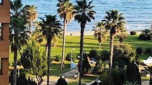 A view of the ocean from a building with palm trees and a grassy area. - Seafront Apartment 'Vistamar' with Sea Views, Wi-Fi & Air Conditioning (Oropesa)