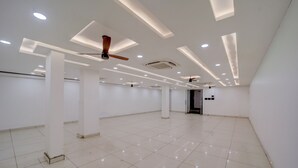 A spacious, well-lit room with a high ceiling, recessed lighting, and a ceiling fan. - The Byke Boutique Urban Nest (Bhopal)