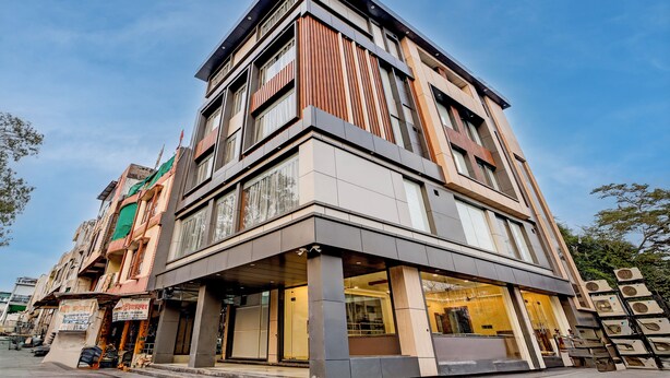 A multi-story building with a modern design, featuring large windows and a corner entrance. - The Byke Boutique Urban Nest (Bhopal)
